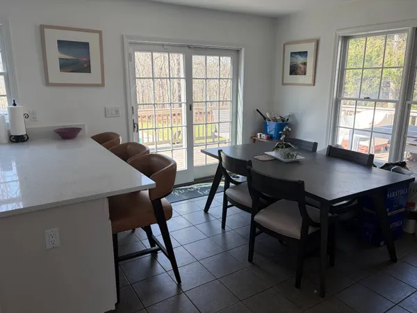 a view of a dining room with furniture and window
