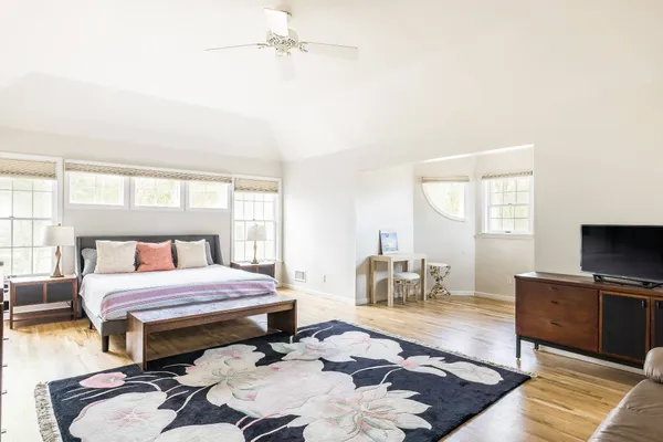 a bedroom with a bed and wooden floor