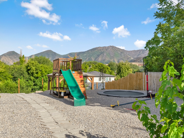 523 South Main Street Payson, UT 84651 - Photo 36 of 41 Expansive outdoor area featuring a stone paver pathway, gravel ground cover, and mature green trees