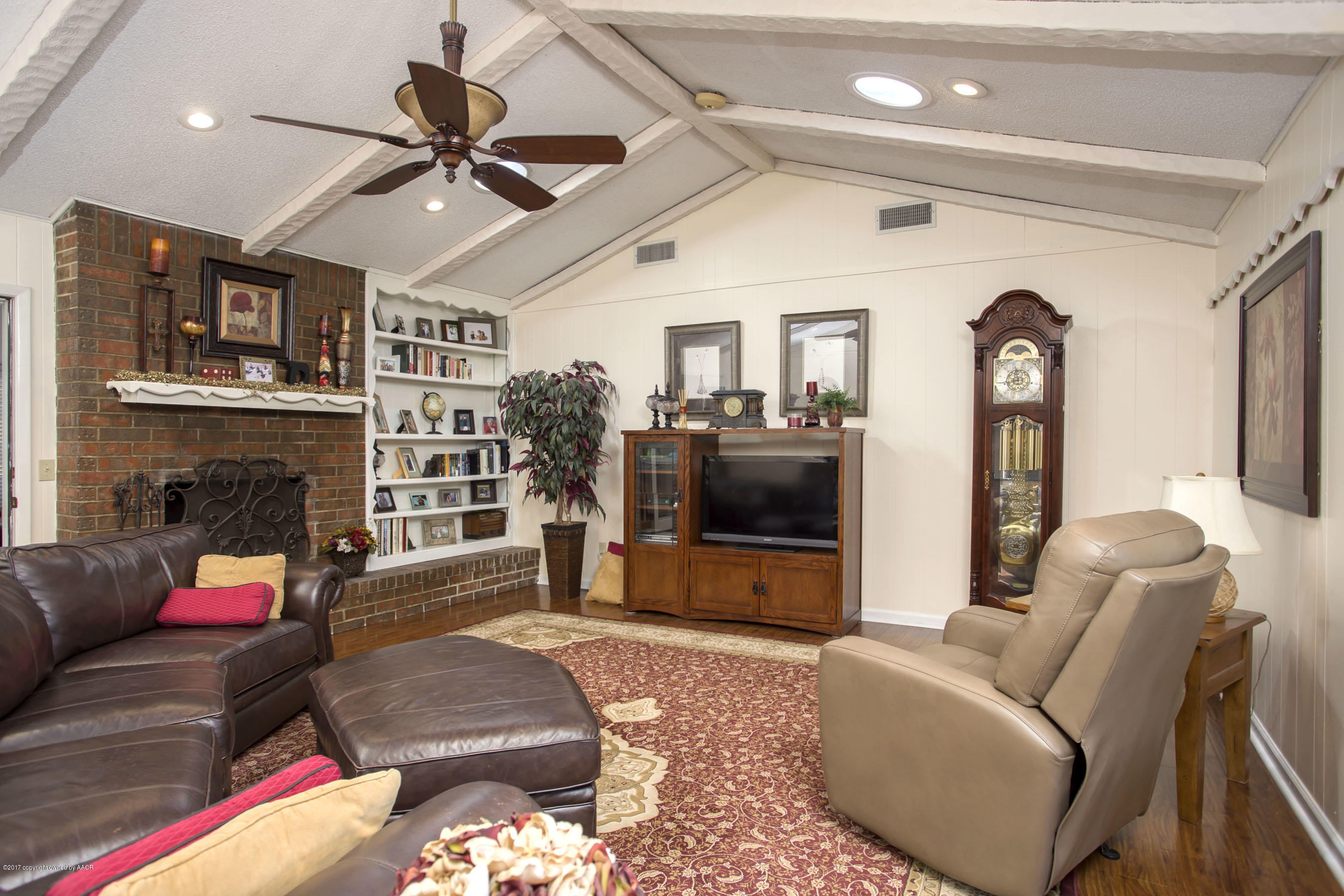 7202 Gainsborough Road Amarillo, TX 79106 - Photo 4 of 27 a living room with furniture and a fireplace