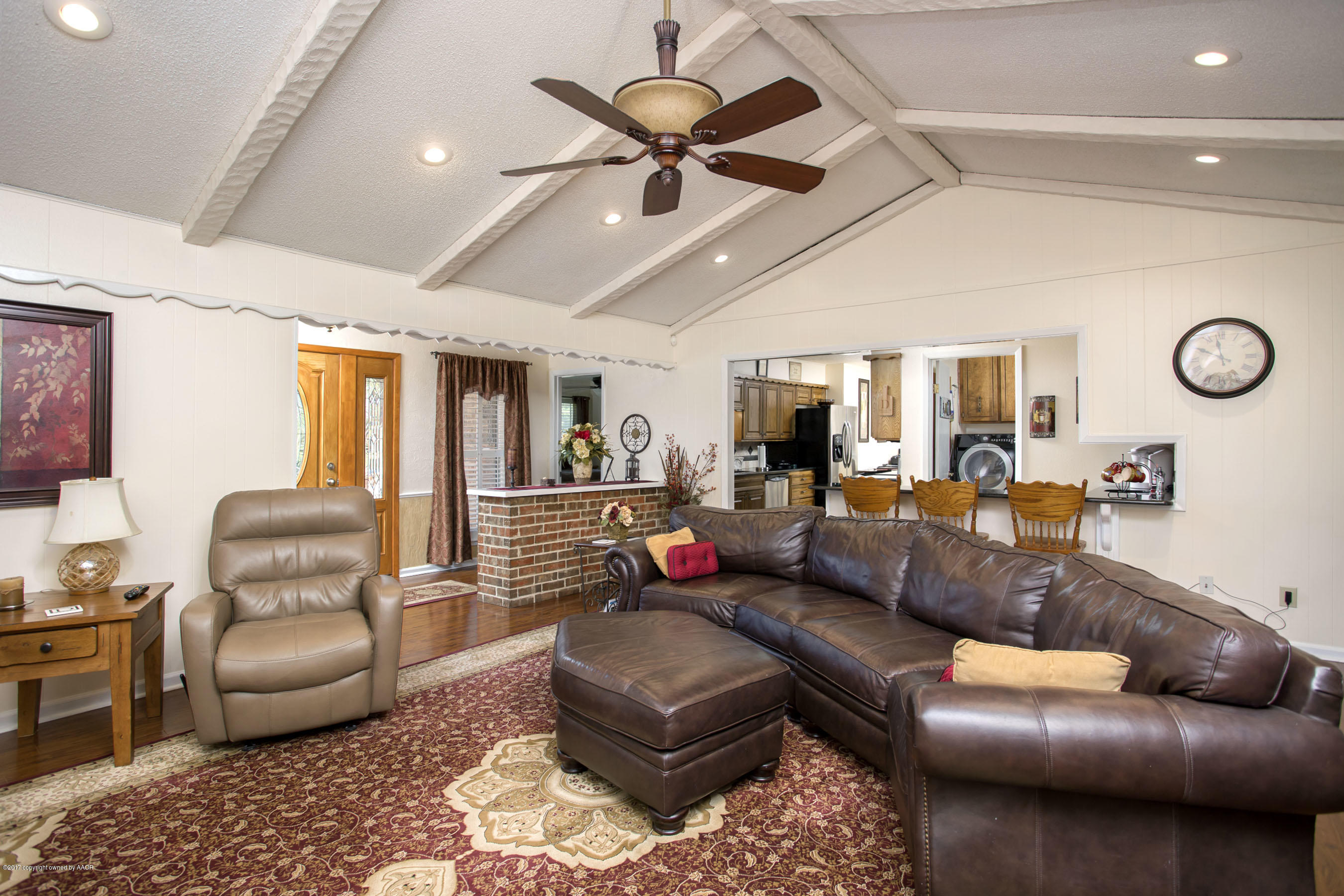 7202 Gainsborough Road Amarillo, TX 79106 - Photo 5 of 27 a living room with furniture ceiling fan and a rug