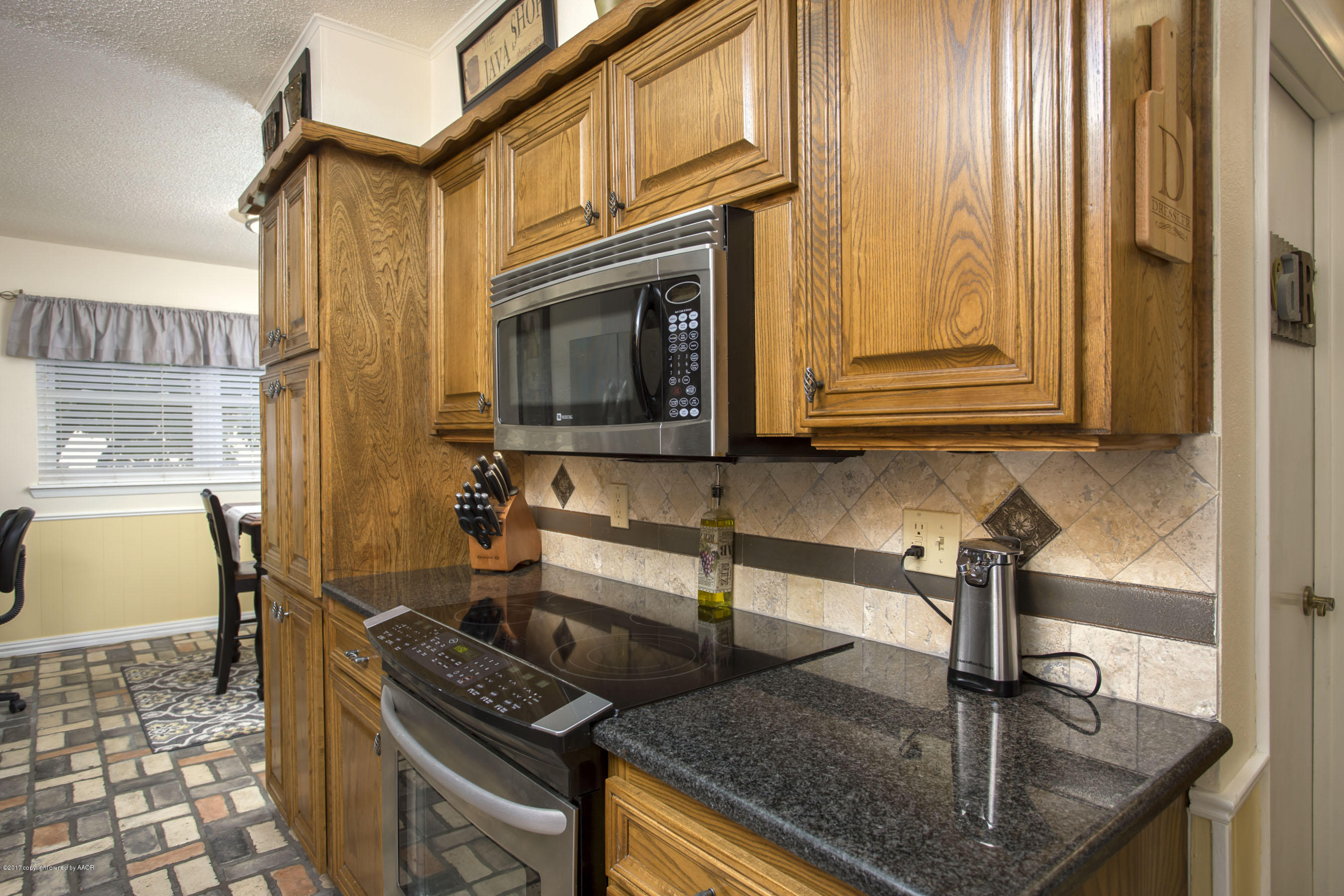 7202 Gainsborough Road Amarillo, TX 79106 - Photo 8 of 27 a kitchen with stainless steel appliances granite countertop a sink stove and cabinets