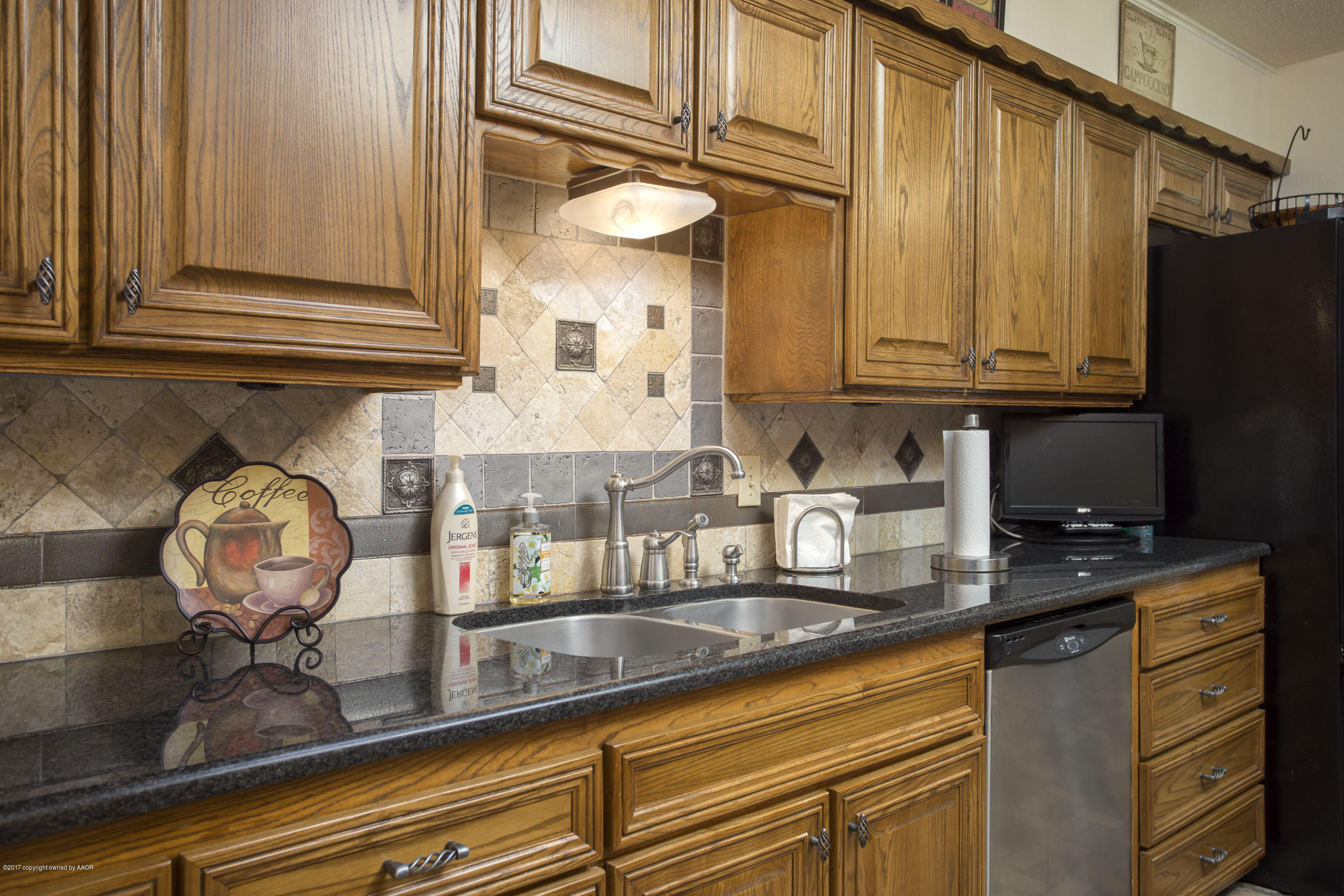 7202 Gainsborough Road Amarillo, TX 79106 - Photo 9 of 27 a kitchen with stainless steel appliances granite countertop a sink and cabinets