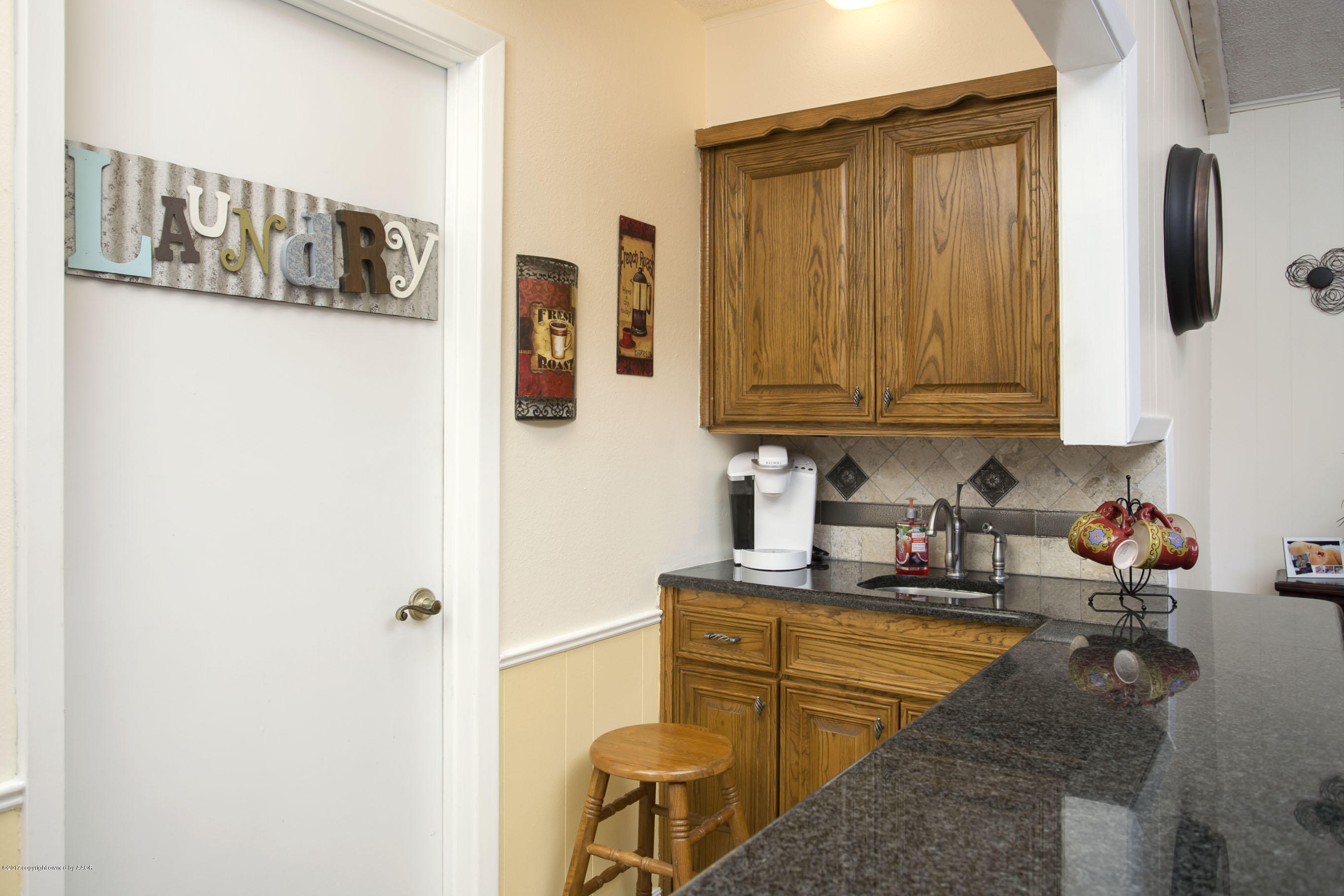7202 Gainsborough Road Amarillo, TX 79106 - Photo 10 of 27 a kitchen with sink refrigerator and microwave