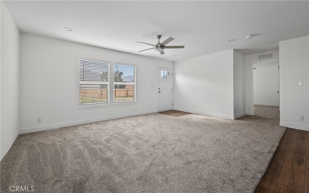 13425 Mesquite Road Whitewater, CA 92282 - Photo 11 of 26 an empty room with windows and ceiling fan