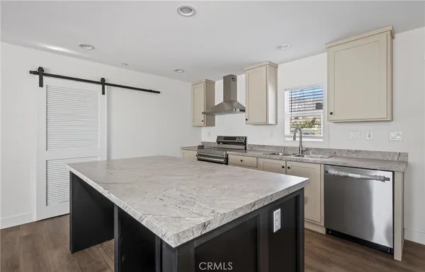 a kitchen with a stove a sink and a refrigerator