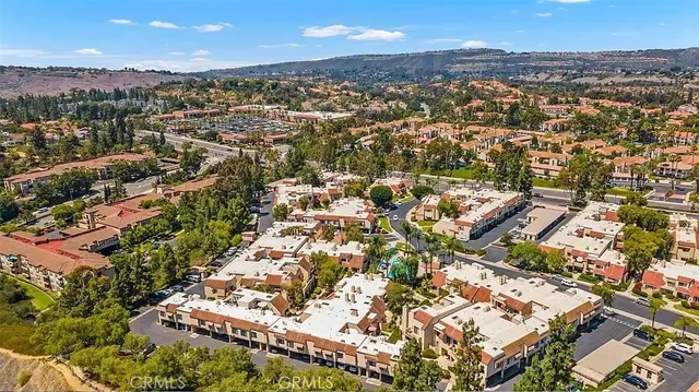 an aerial view of residential houses with city view