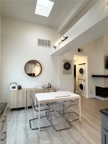 a living room with table chairs and a large window