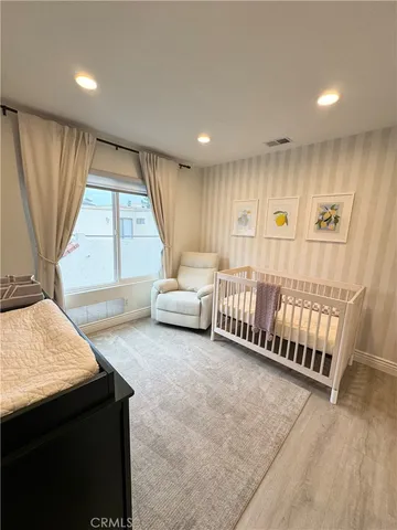 a spacious bedroom with a bed and a window