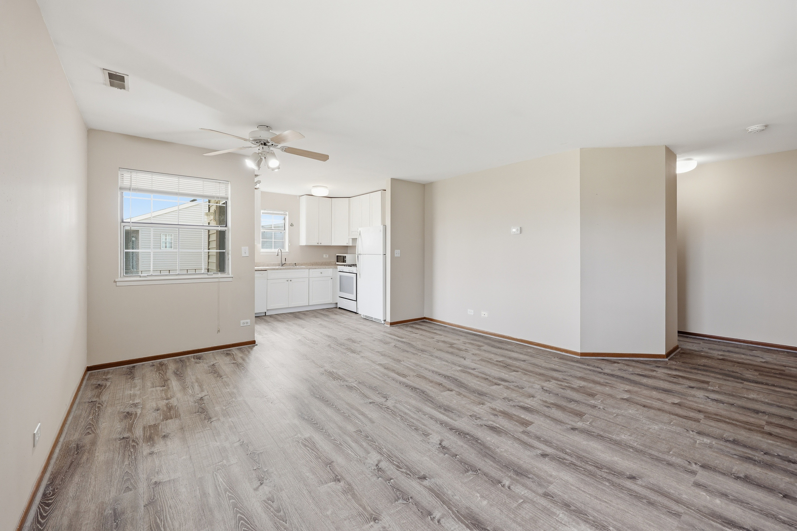 36 Gant Circle, Unit H Streamwood, IL 60107 - Photo 7 of 22 a view of empty room with wooden floor and window