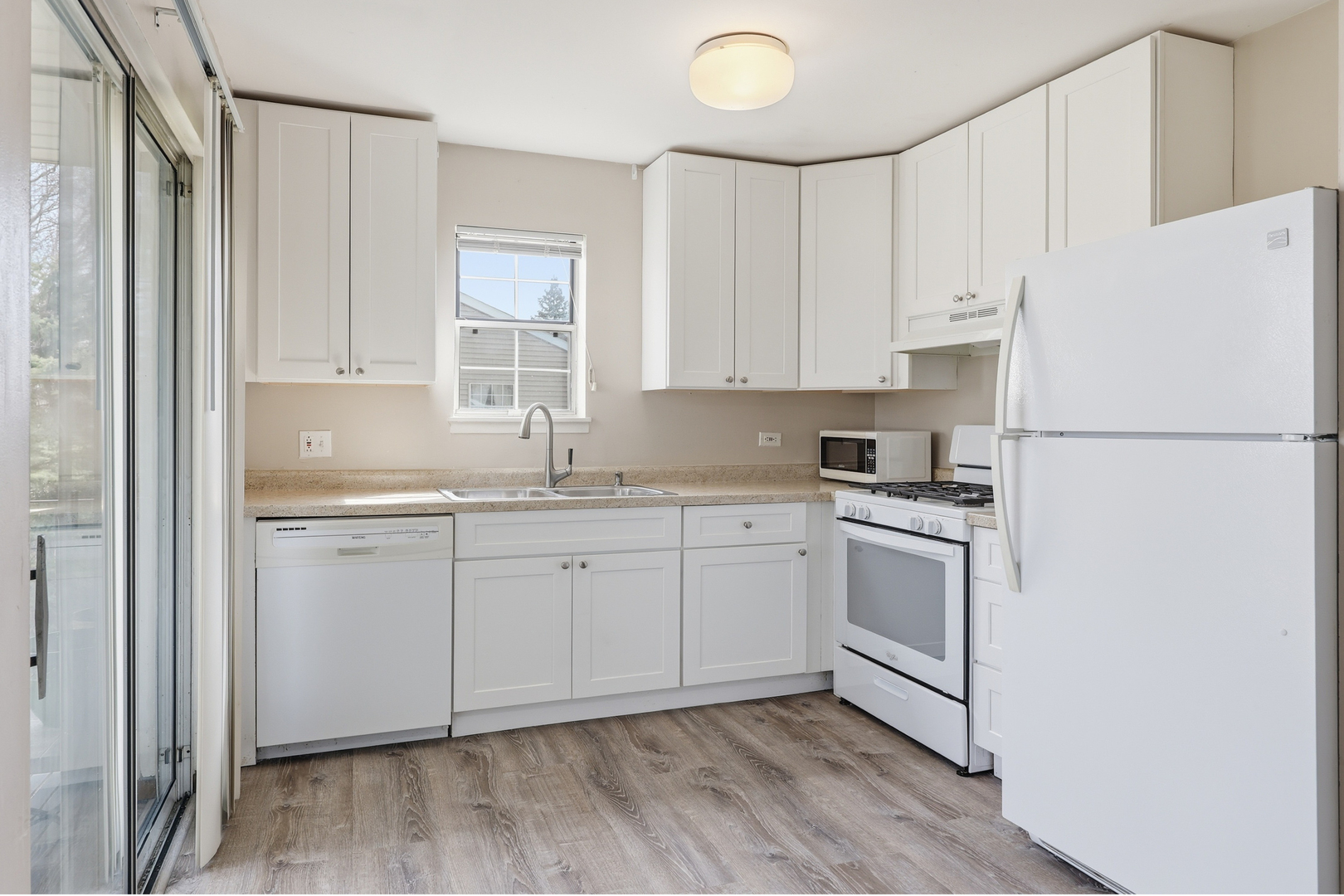 36 Gant Circle, Unit H Streamwood, IL 60107 - Photo 8 of 22 a kitchen with granite countertop white cabinets and white appliances