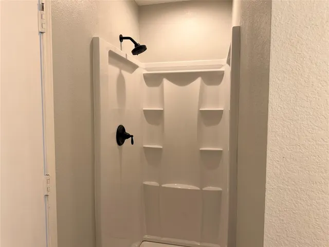 a bathroom with a granite countertop sink and a toilet