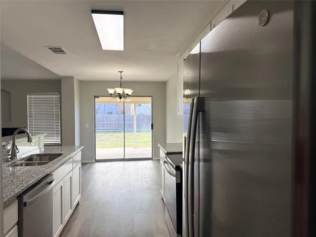 a view of a kitchen with a sink and a window