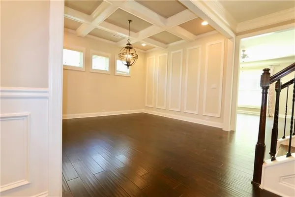 a view of a livingroom with wooden floor and a window