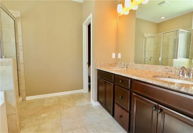 a bathroom with a double vanity sink and a mirror