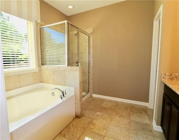 a bathroom with a bathtub and a shower
