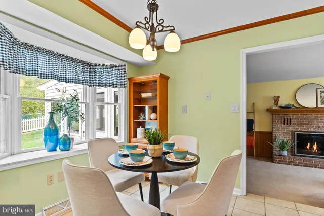 a view of a dining room with furniture and chandelier