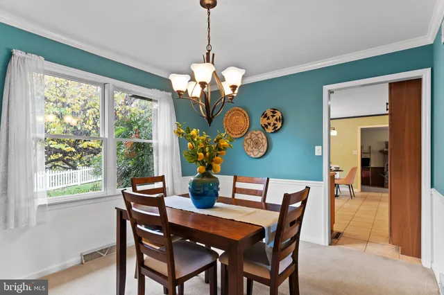 a living room with furniture and large windows