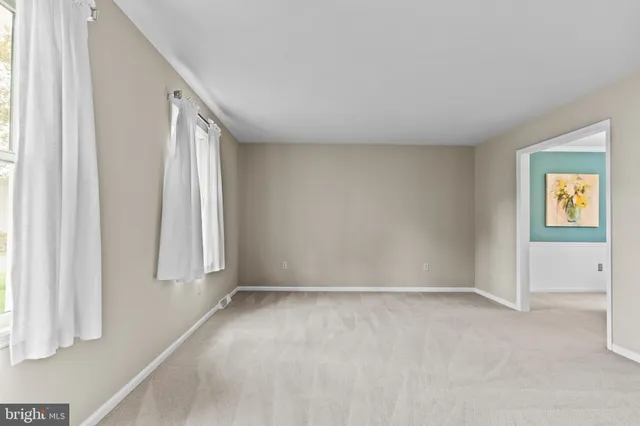 a dining room with furniture a large window and a chandelier