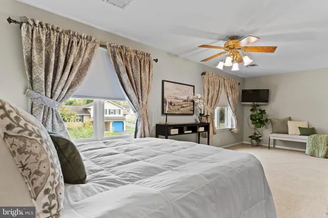 a bathroom with a granite countertop sink a toilet and mirror
