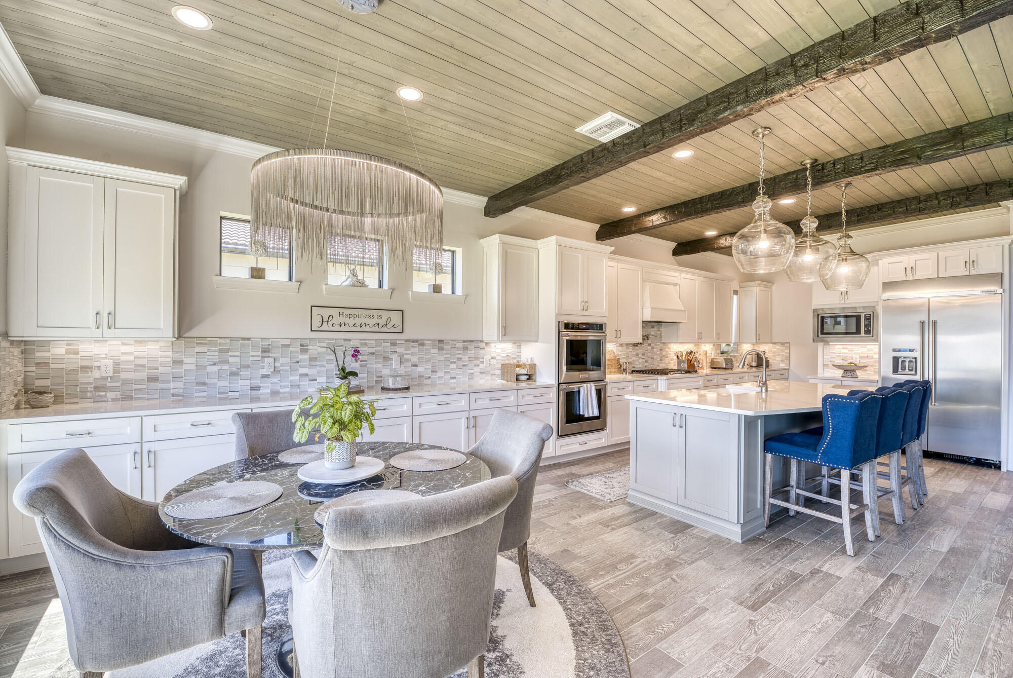 114 Cinder Dunes Point Jupiter, FL 33478 - Photo 11 of 62 a kitchen with a dining table chairs sink and cabinets