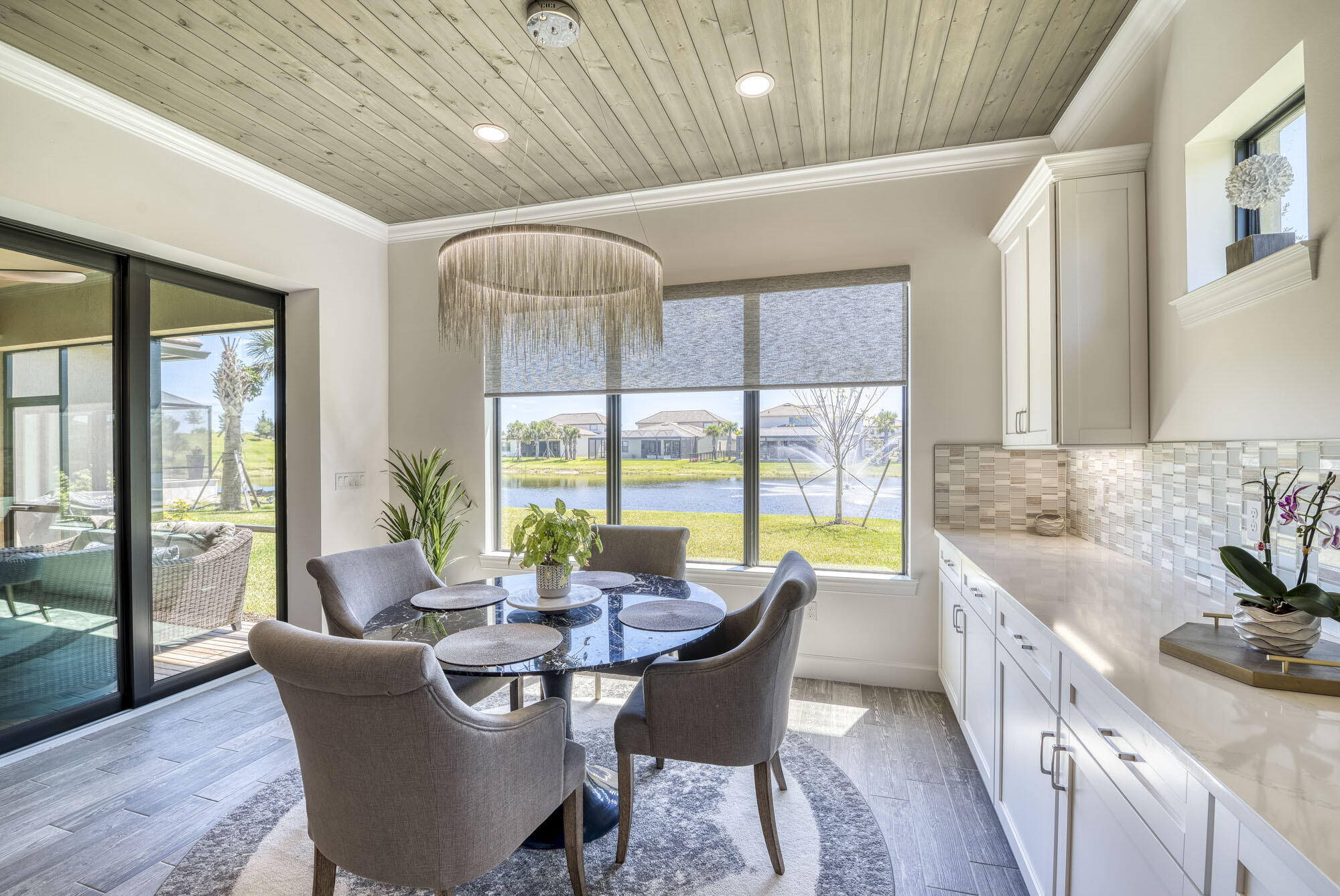 114 Cinder Dunes Point Jupiter, FL 33478 - Photo 12 of 62 a view of a dining room with furniture large windows and wooden floor