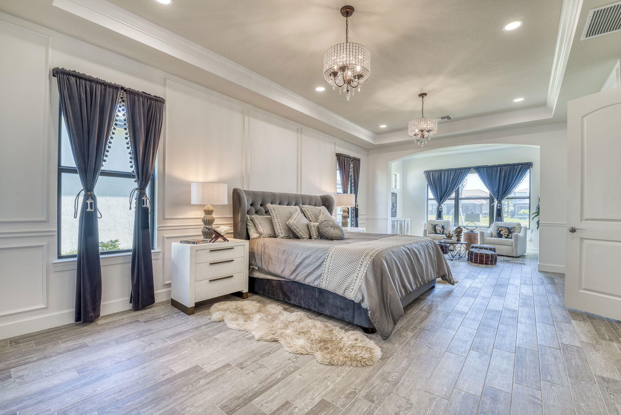 114 Cinder Dunes Point Jupiter, FL 33478 - Photo 23 of 62 a spacious bedroom with a large bed and a chandelier