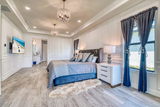 a bedroom with a bed and a painting on the wall