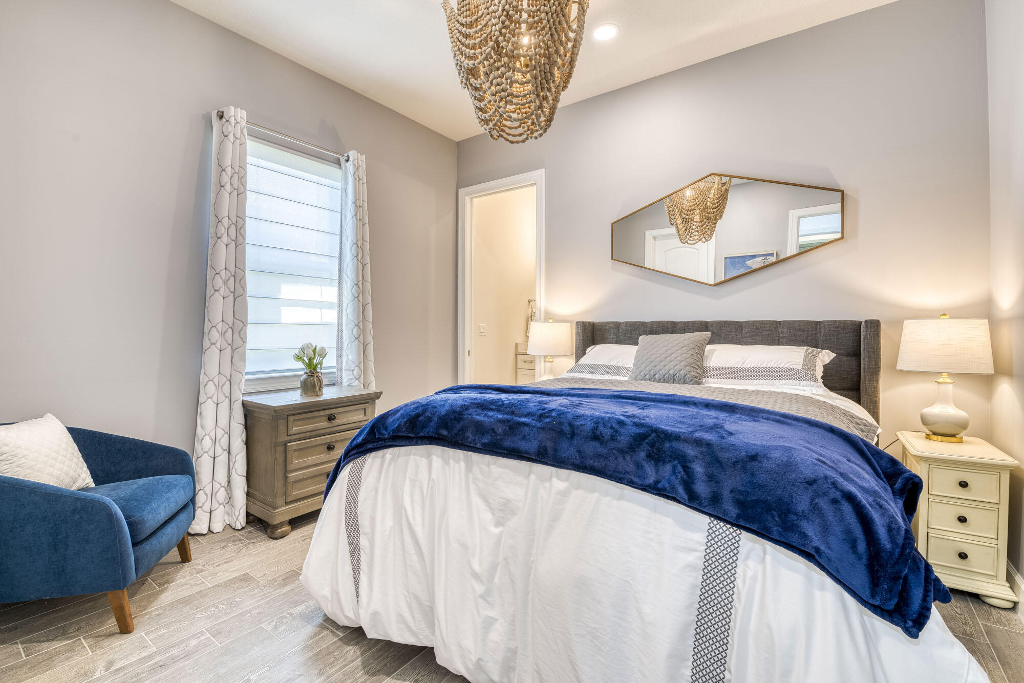 114 Cinder Dunes Point Jupiter, FL 33478 - Photo 33 of 62 a bedroom with a bed and a painting on the wall