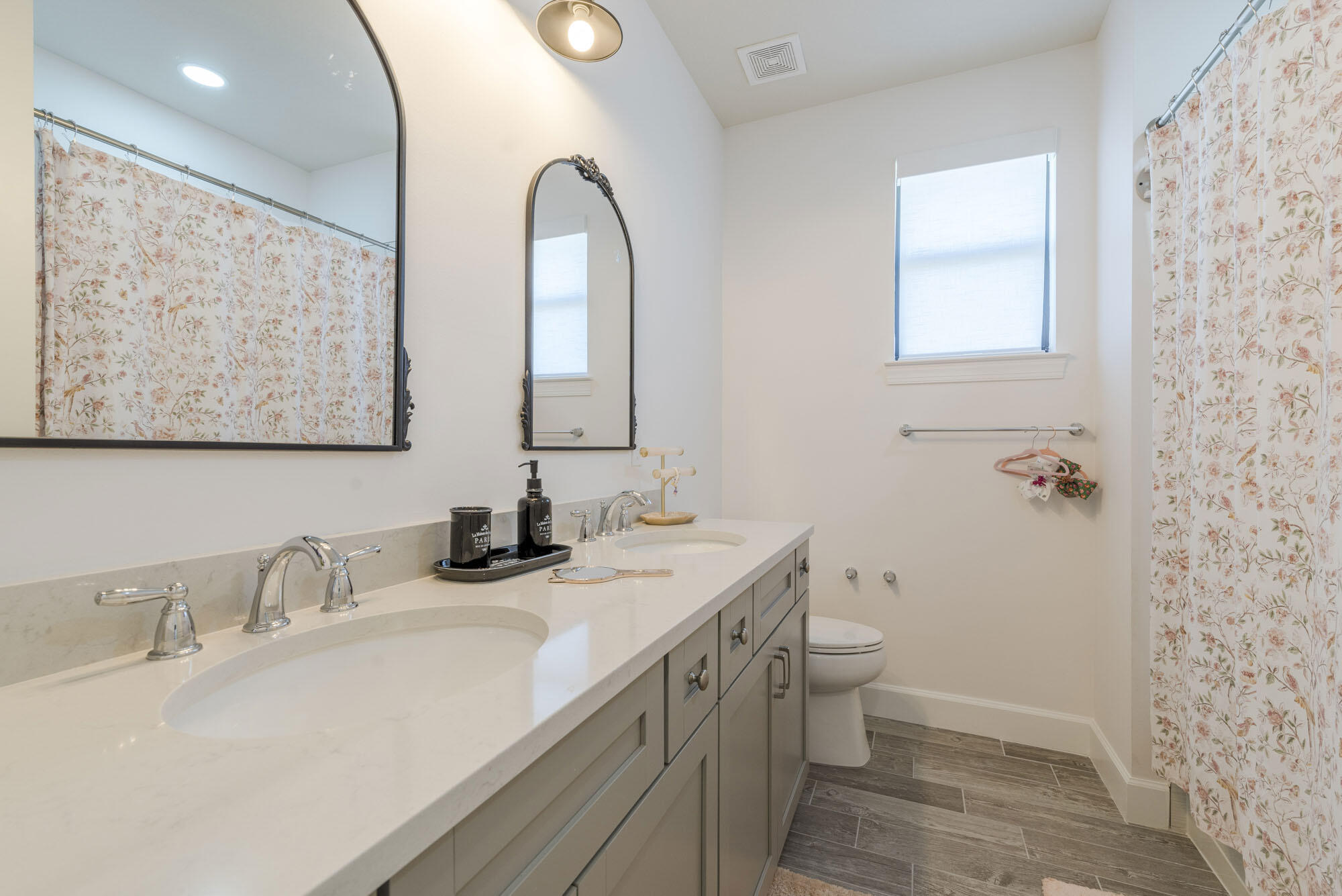 114 Cinder Dunes Point Jupiter, FL 33478 - Photo 47 of 62 a bathroom with a double vanity sink toilet and a mirror