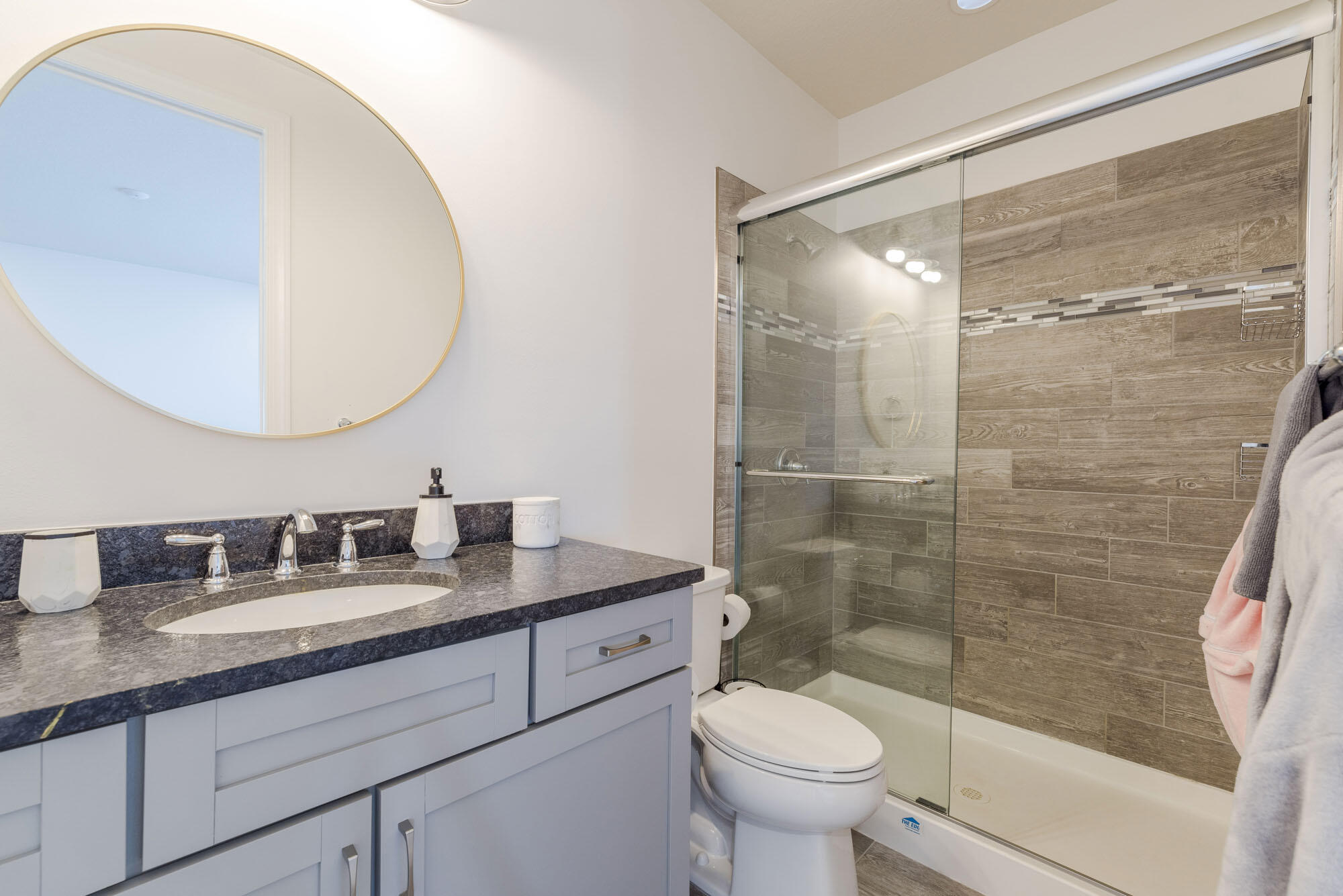 114 Cinder Dunes Point Jupiter, FL 33478 - Photo 49 of 62 a bathroom with a granite countertop sink toilet and shower