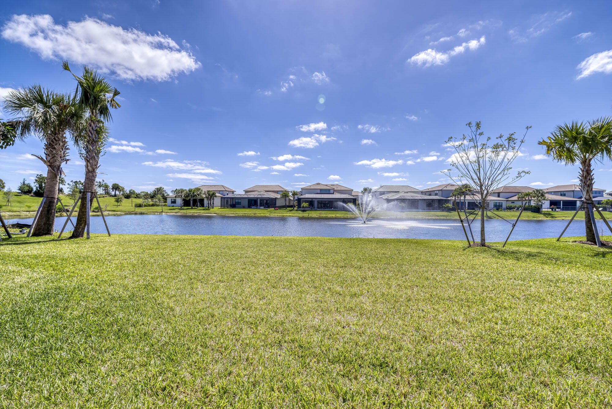 114 Cinder Dunes Point Jupiter, FL 33478 - Photo 54 of 62 a view of a big yard with a swimming pool and outdoor seating