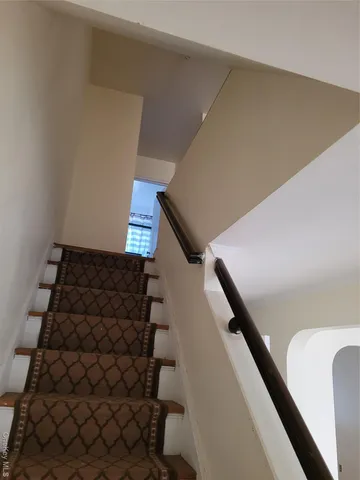 a bedroom with a bed and a mirror