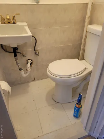 a view of a hallway and a livingroom with furniture