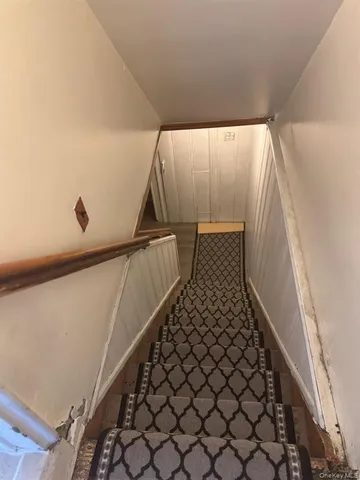 a view of a livingroom with an empty space and a chair