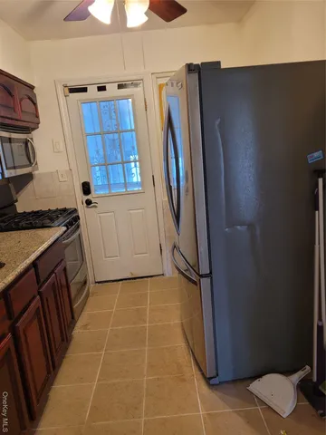 a kitchen with a refrigerator and cabinets