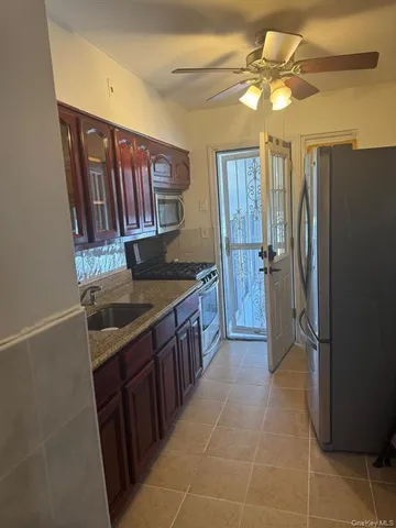 a kitchen with stainless steel appliances granite countertop a stove a refrigerator and a sink