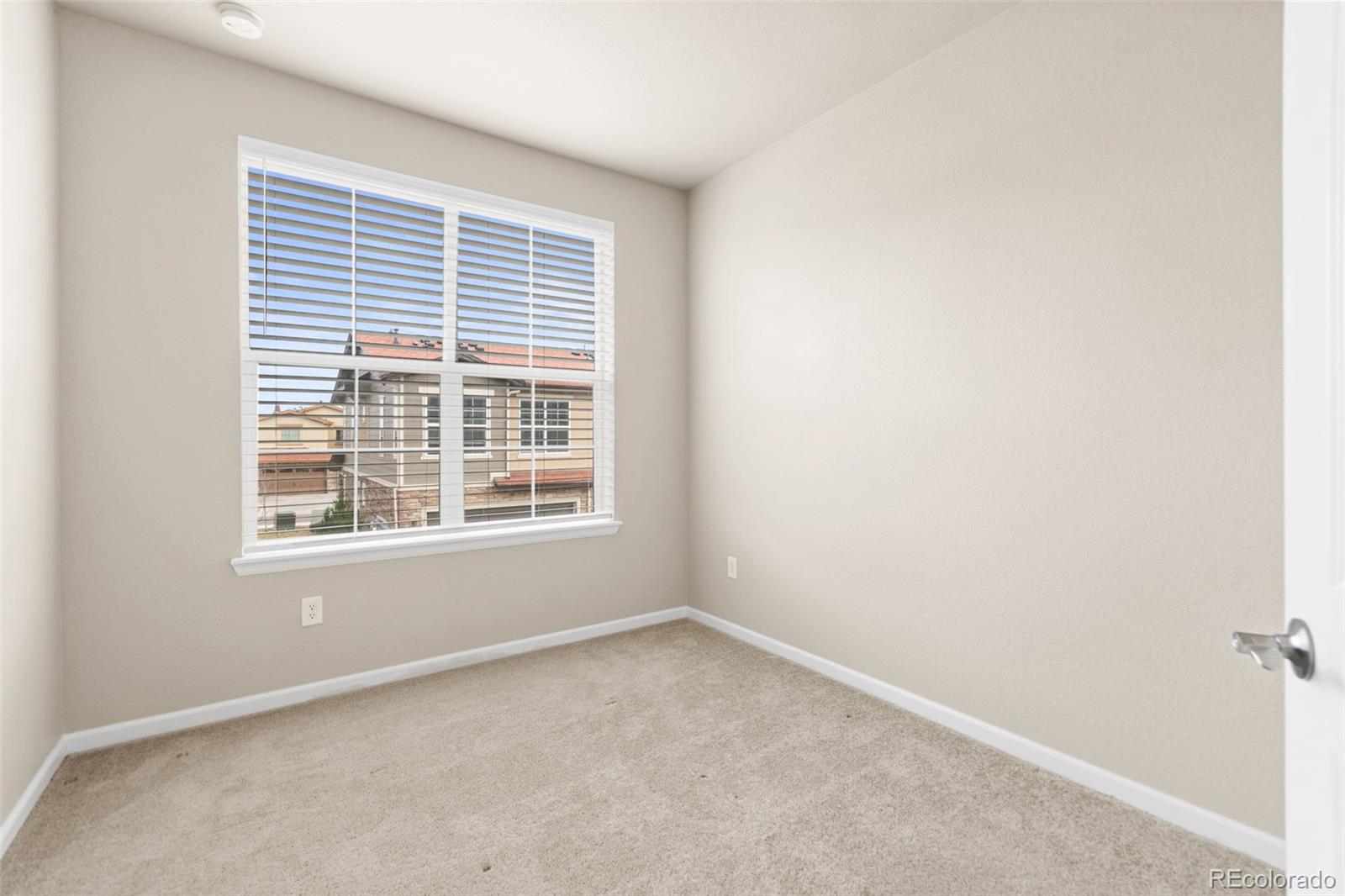 8417 Rizza Street, Unit A Littleton, CO 80129 - Photo 15 of 30 a view of an empty room with a window