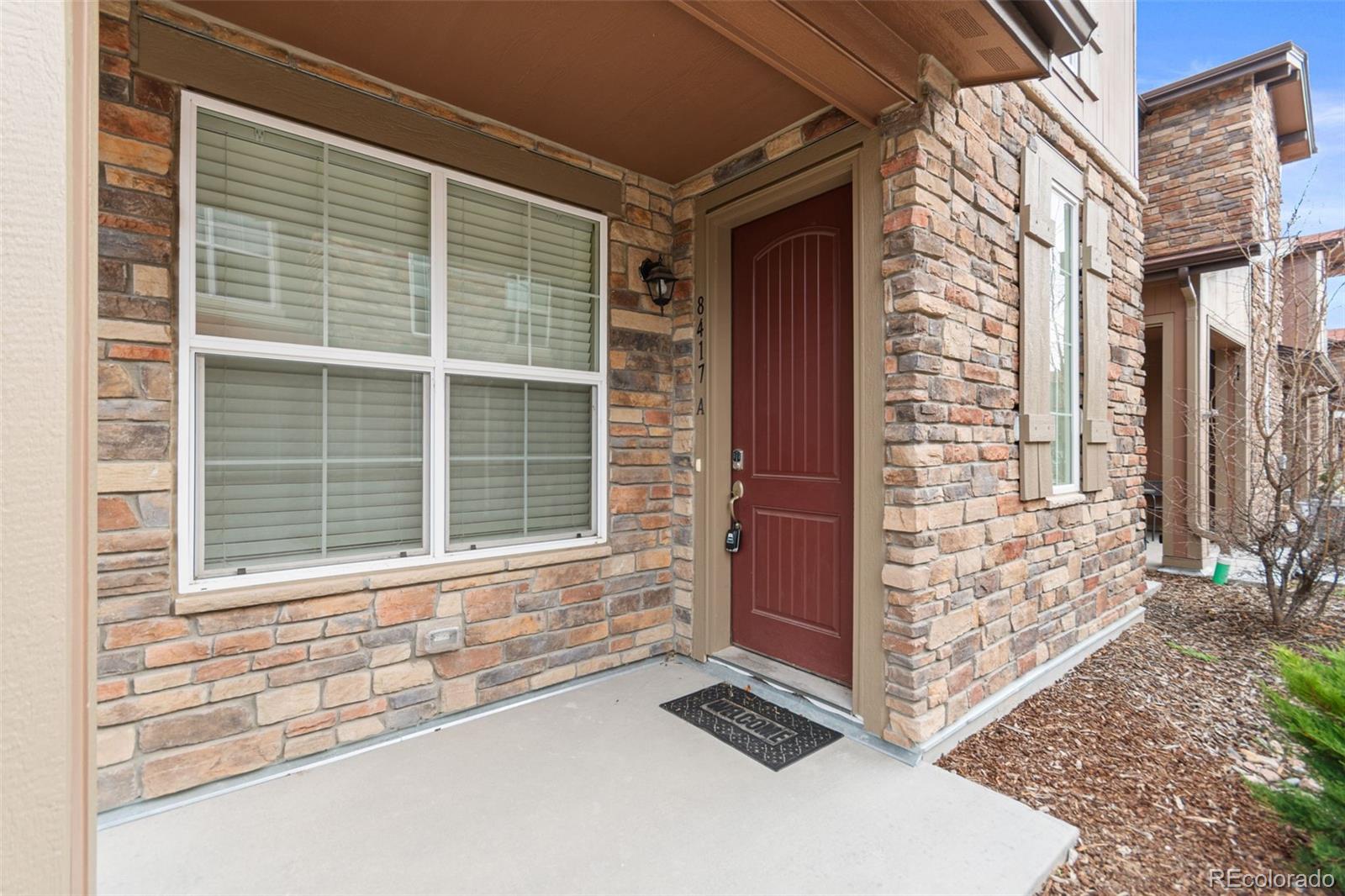 8417 Rizza Street, Unit A Littleton, CO 80129 - Photo 19 of 30 a front view of a house with a yard