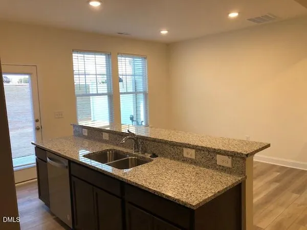 a kitchen with a sink a counter and chair