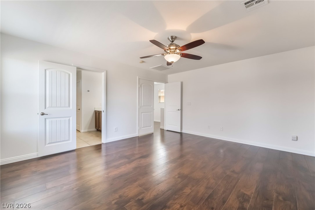 3175 Via Seranova Henderson, NV 89044 - Photo 22 of 45 This primary bedroom features elegant wood flooring, creating a comfortable and inviting atmosphere.