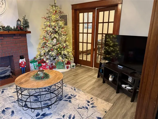 a living room with a table and a fireplace
