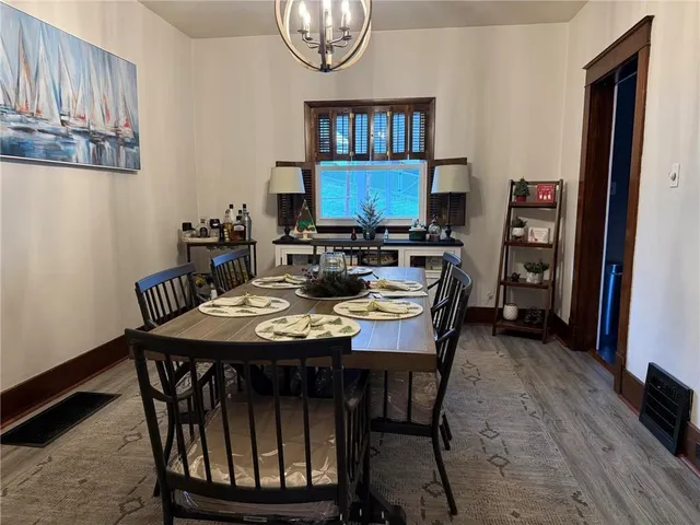 a view of a dining room with furniture and a chandelier
