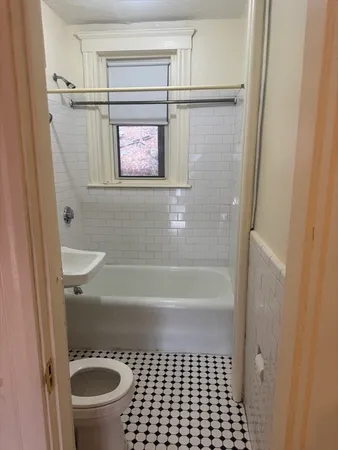 a bathroom with a shower and a toilet