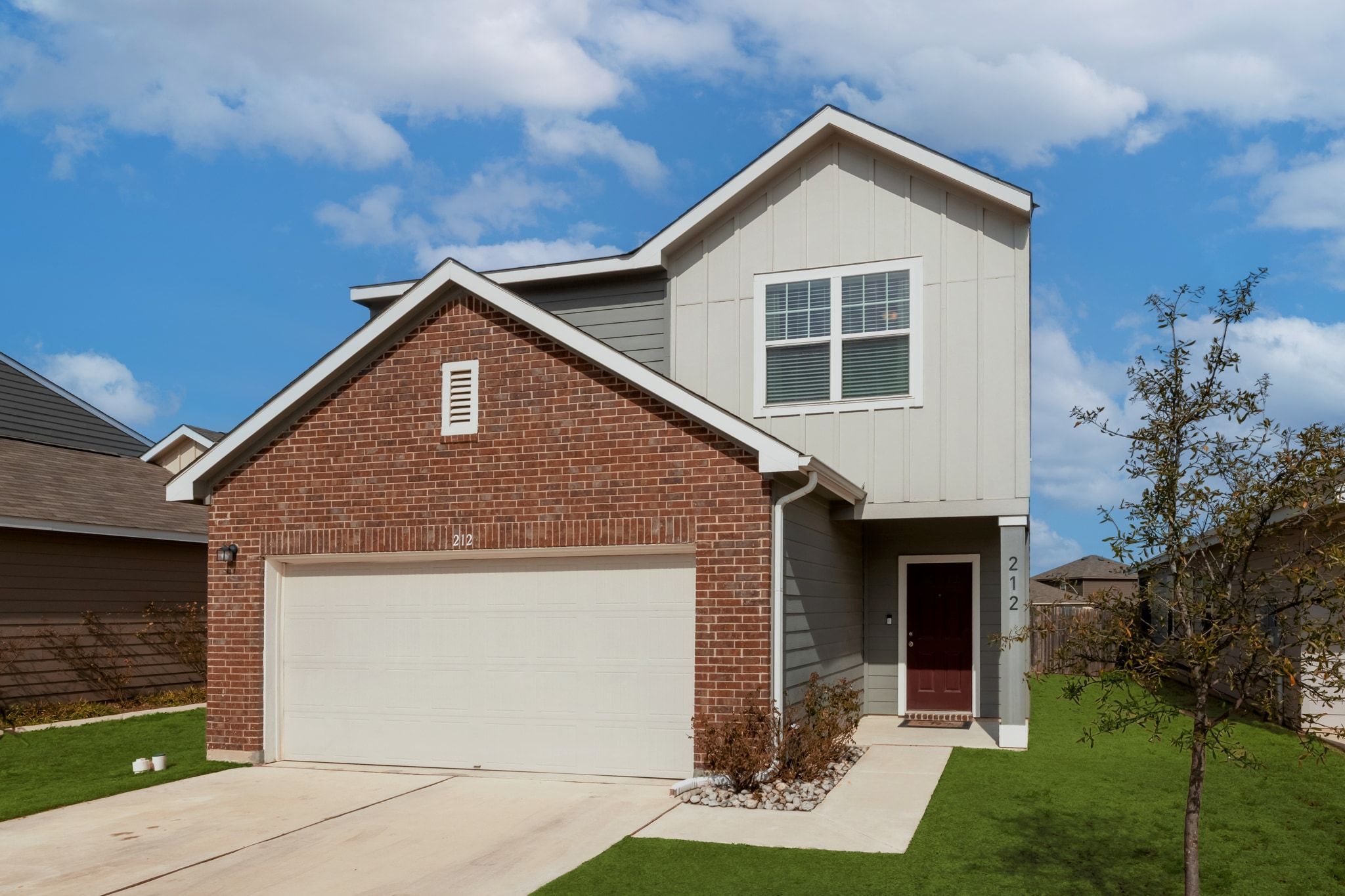 a front view of a house with a yard and garage