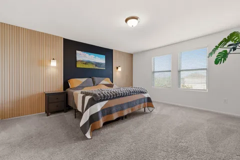 a bedroom with a bed and a window