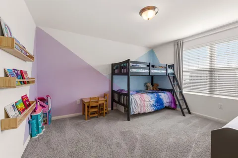 a bedroom with furniture and a window