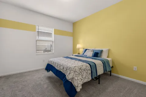 a bedroom with a bed and a window