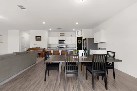 a view of a dining room with furniture and wooden floor