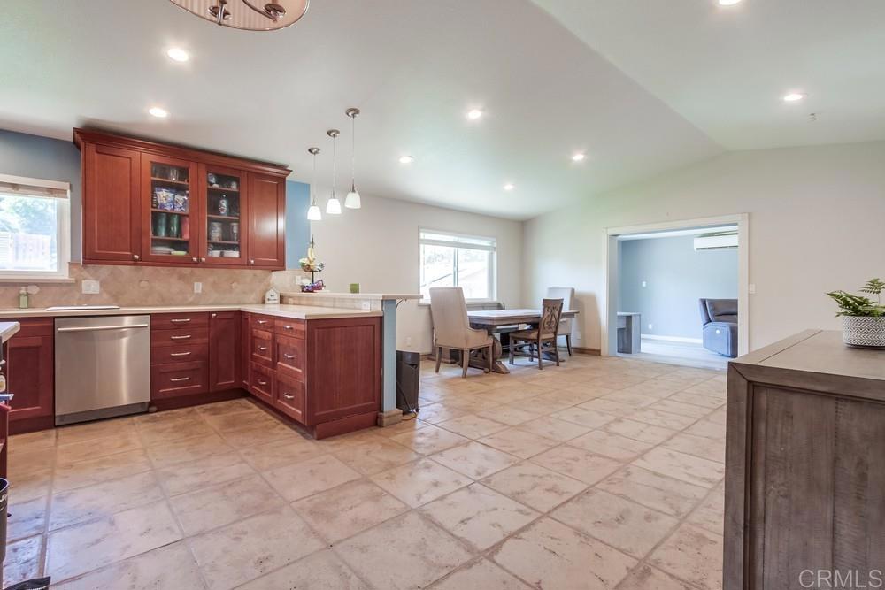 415 3rd Street Ramona, CA 92065 - Photo 11 of 33 a kitchen with stainless steel appliances granite countertop a sink and cabinets